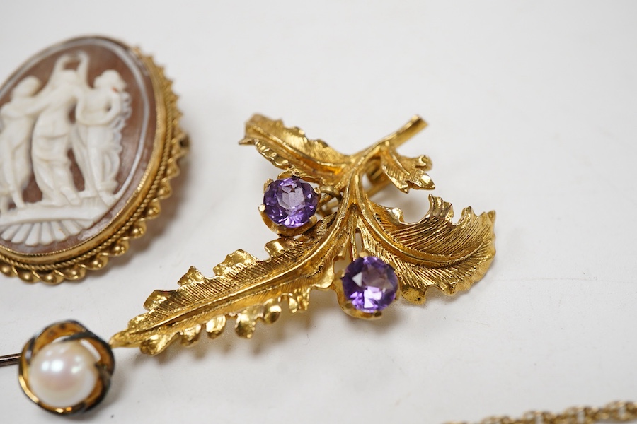 A collection 9ct brooches to include a shell cameo carved with the Three Graces, an amethyst set floral spray brooch, a cultured pearl set ribbon brooch, a garnet set bar brooch and a cultured pearl set stick pin, togeth